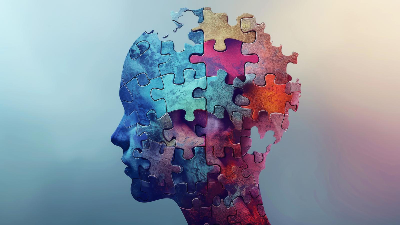 künstlerische Darstellung eines Kopfes mit Gehirn aus bunten Puzzleteilen
