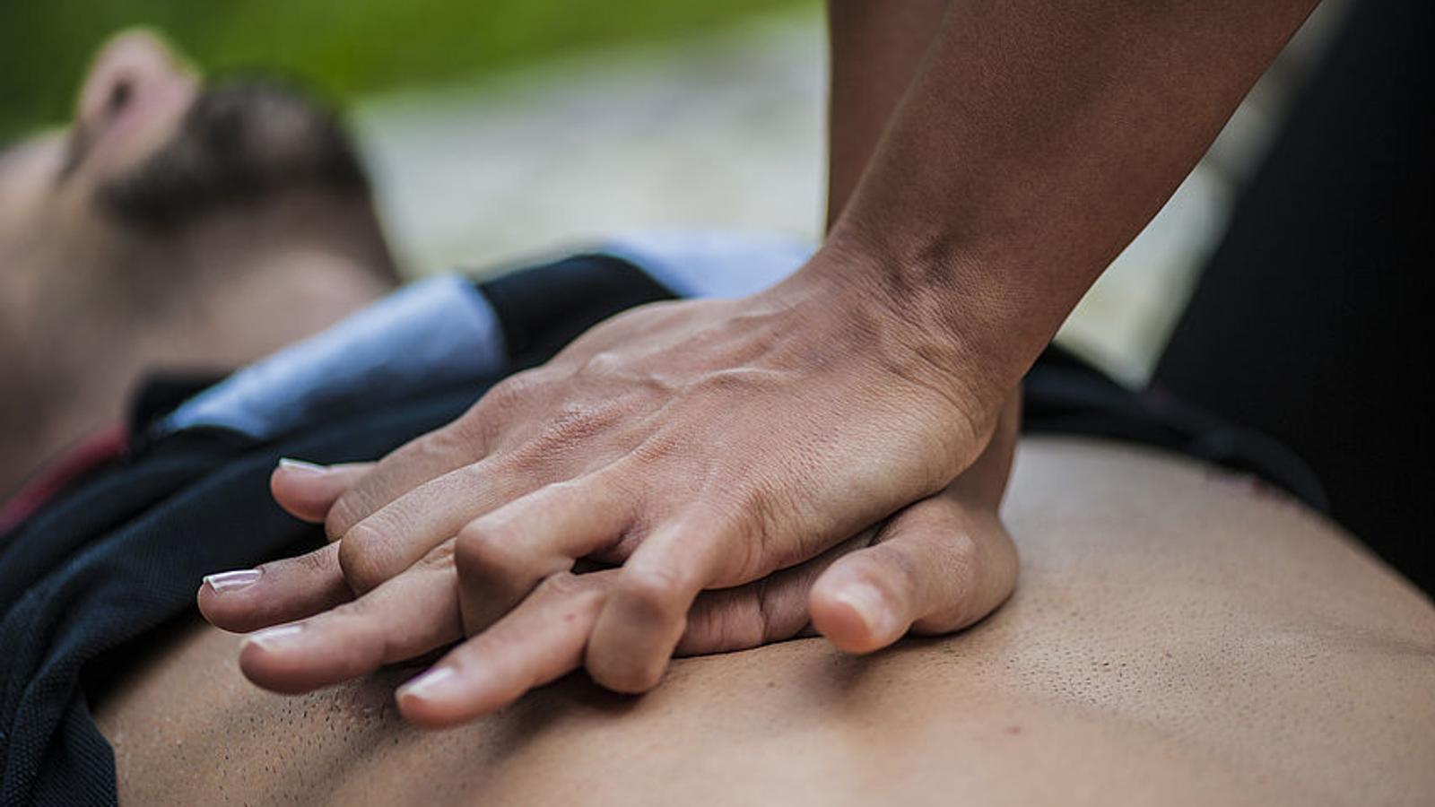 Frau führt bei einem Mann eine Herzdruckmassage durch