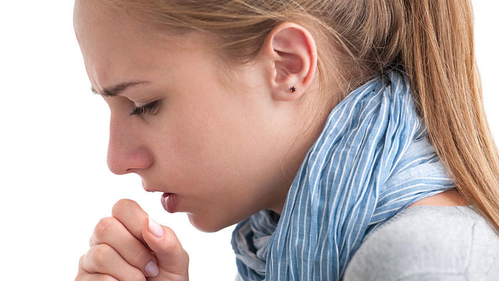 Junge Frau leidet an einer Bronchitis und muss husten. 